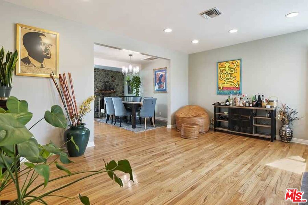8460 Hatillo Avenue Winnetka, CA 91306 - Photo 2 of 19 a living room with furniture and a wooden floor