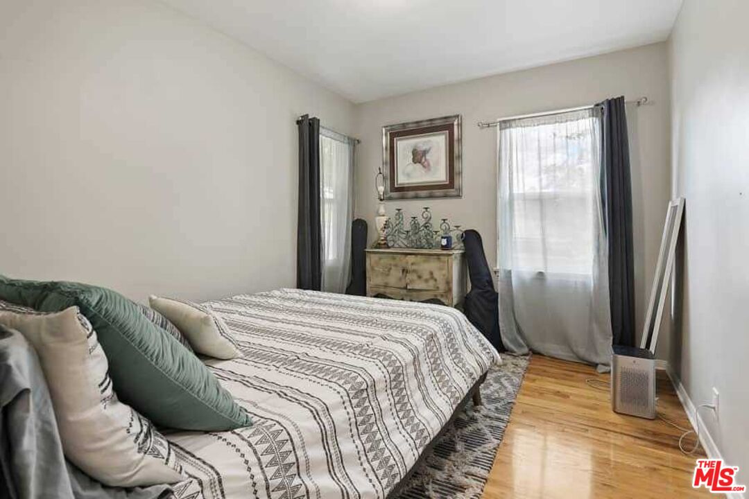 8460 Hatillo Avenue Winnetka, CA 91306 - Photo 11 of 19 a bedroom with a bed and a window