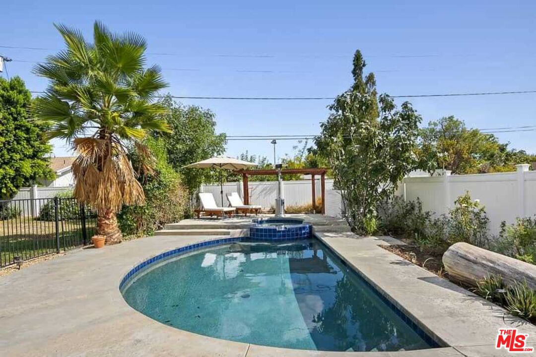 8460 Hatillo Avenue Winnetka, CA 91306 - Photo 16 of 19 a view of a swimming pool with a patio