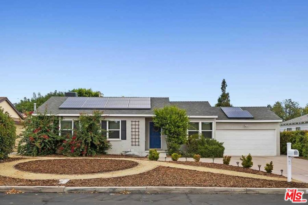 8460 Hatillo Avenue Winnetka, CA 91306 - Photo 19 of 19 a front view of a house with a yard