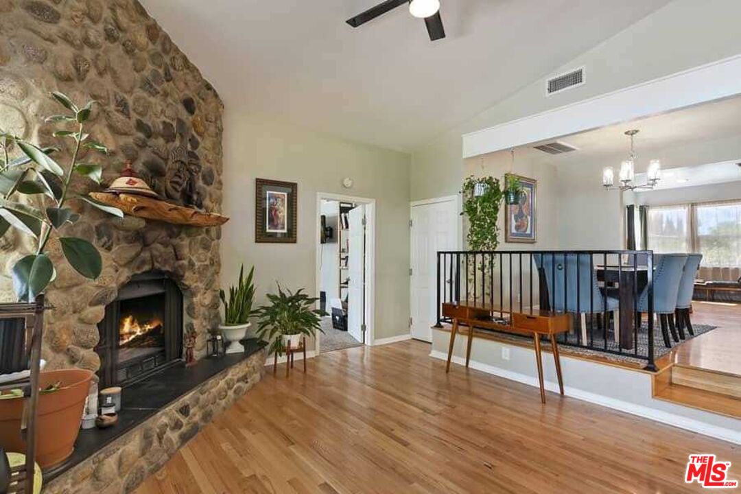 8460 Hatillo Avenue Winnetka, CA 91306 - Photo 5 of 19 a living room with furniture and a fireplace