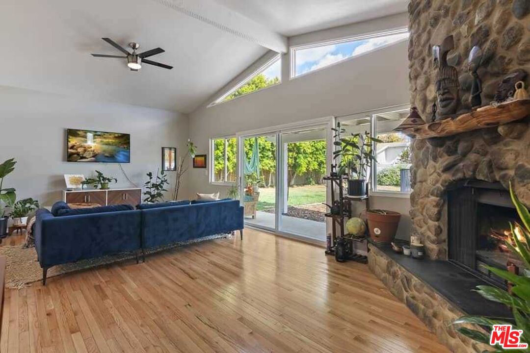 8460 Hatillo Avenue Winnetka, CA 91306 - Photo 7 of 19 a living room with furniture and a fireplace