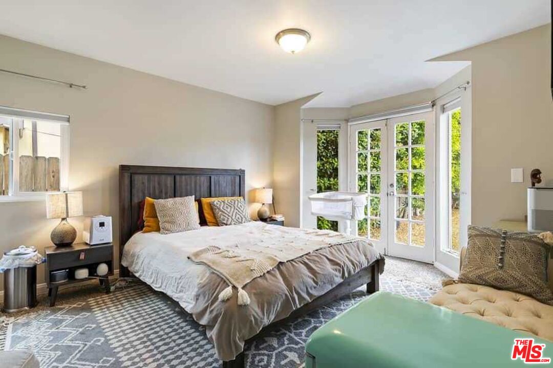 8460 Hatillo Avenue Winnetka, CA 91306 - Photo 9 of 19 a bedroom with a bed and wooden floor