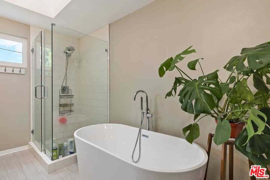 8460 Hatillo Avenue Winnetka, CA 91306 - Photo 10 of 19 a bath tub sitting next to a white sink