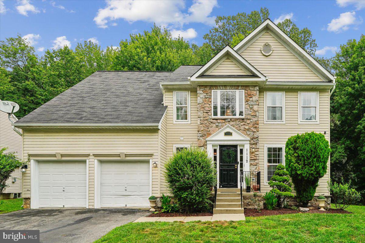 1112 Ryon Way District Heights, MD 20747 - Photo 1 of 63 a front view of a house with a yard and garage