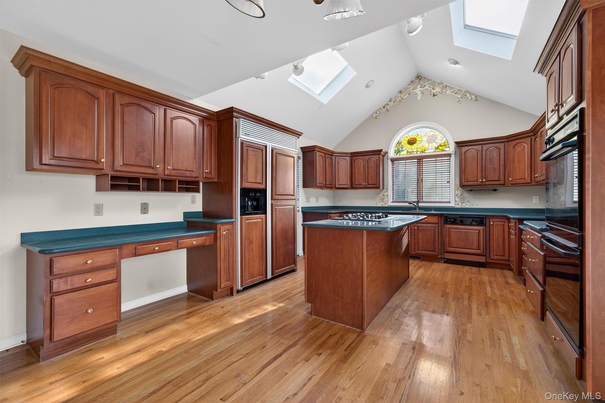 21 Jessup Road Warwick, NY 10990 - Photo 16 of 50 a kitchen with stainless steel appliances granite countertop wooden floors wooden cabinets and sink
