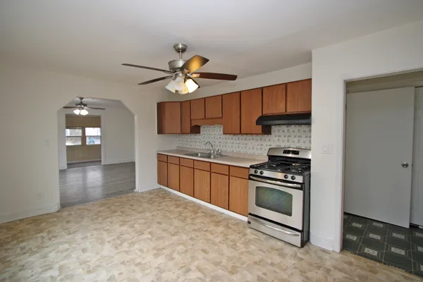 a kitchen with stainless steel appliances a stove a sink and a refrigerator