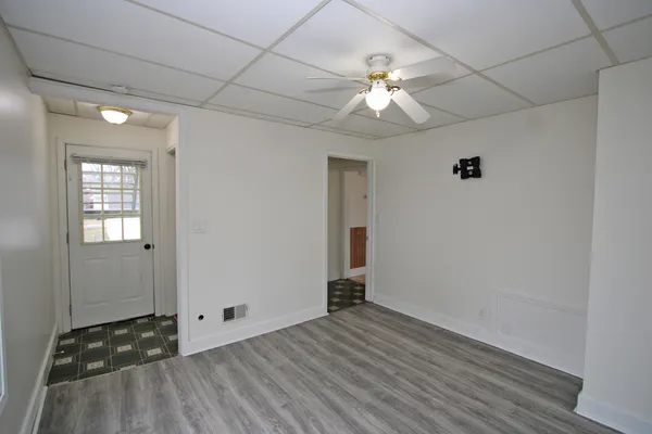 wooden floor in an empty room with a window