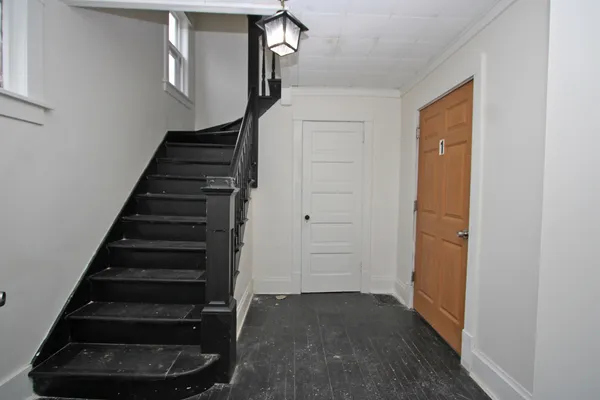 a view of entryway and hall with wooden floor