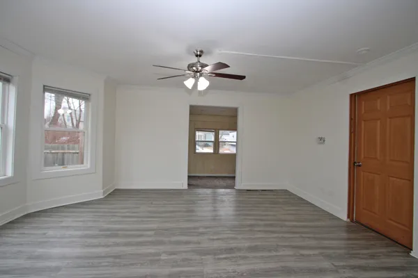 wooden floor in an empty room with a window