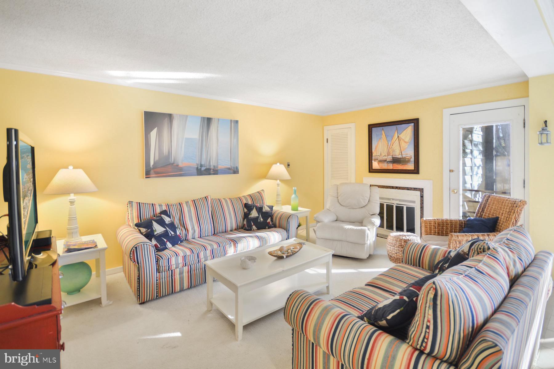 119 Old Landing Road, Unit 204J Ocean City, MD 21842 - Photo 11 of 35 a living room with furniture and a flat screen tv