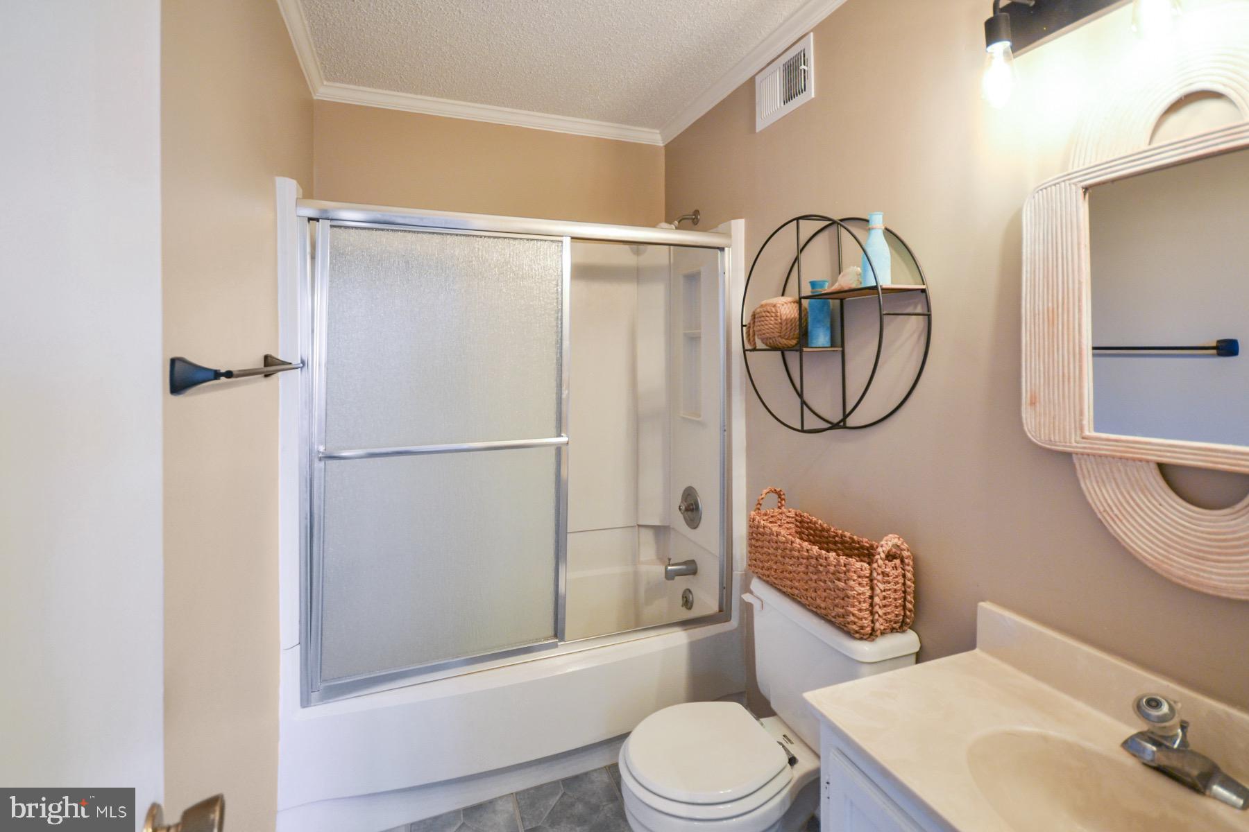 119 Old Landing Road, Unit 204J Ocean City, MD 21842 - Photo 15 of 35 a bathroom with a toilet a sink and a mirror