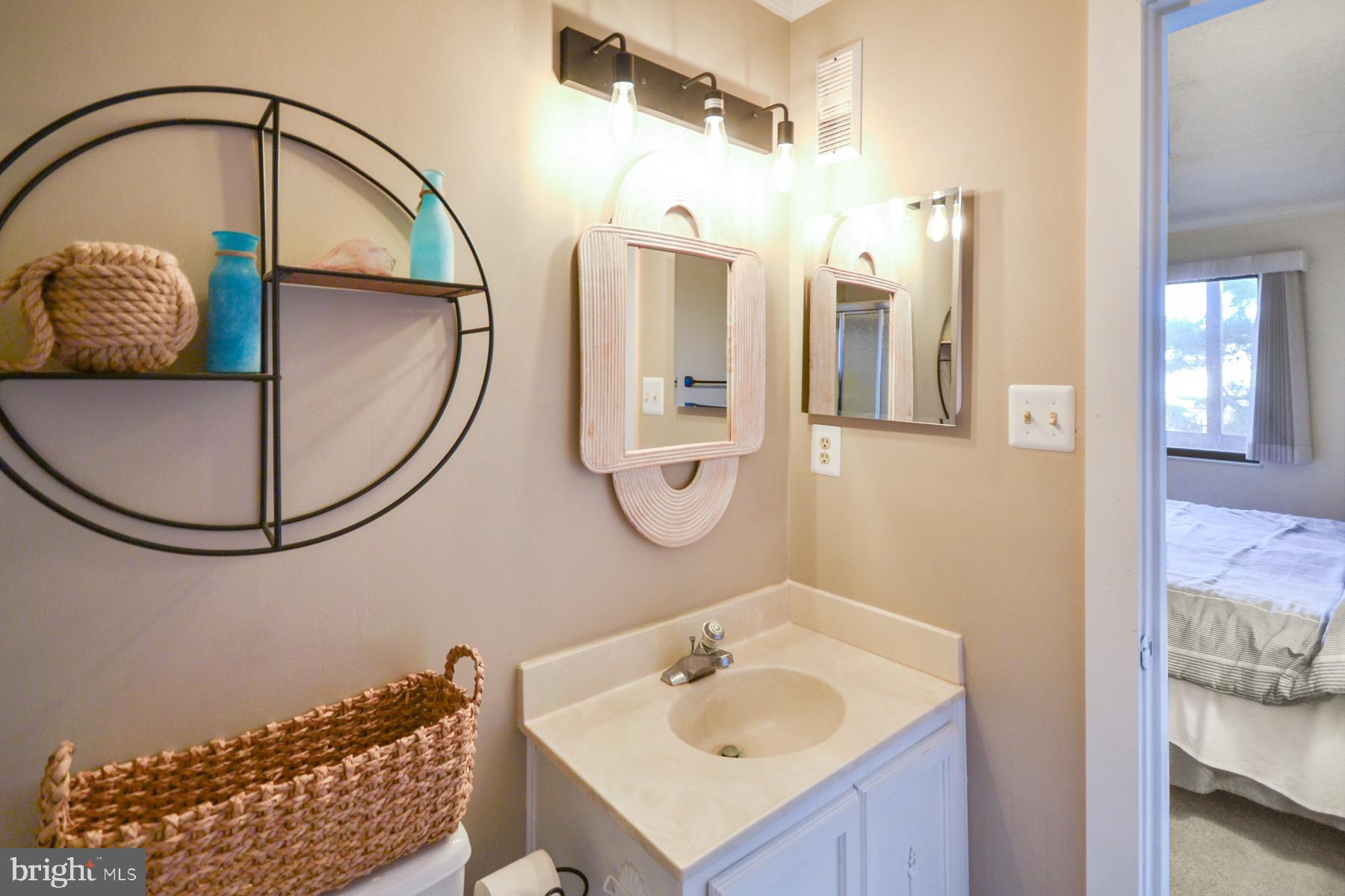 119 Old Landing Road, Unit 204J Ocean City, MD 21842 - Photo 17 of 35 a bathroom with a sink and a mirror
