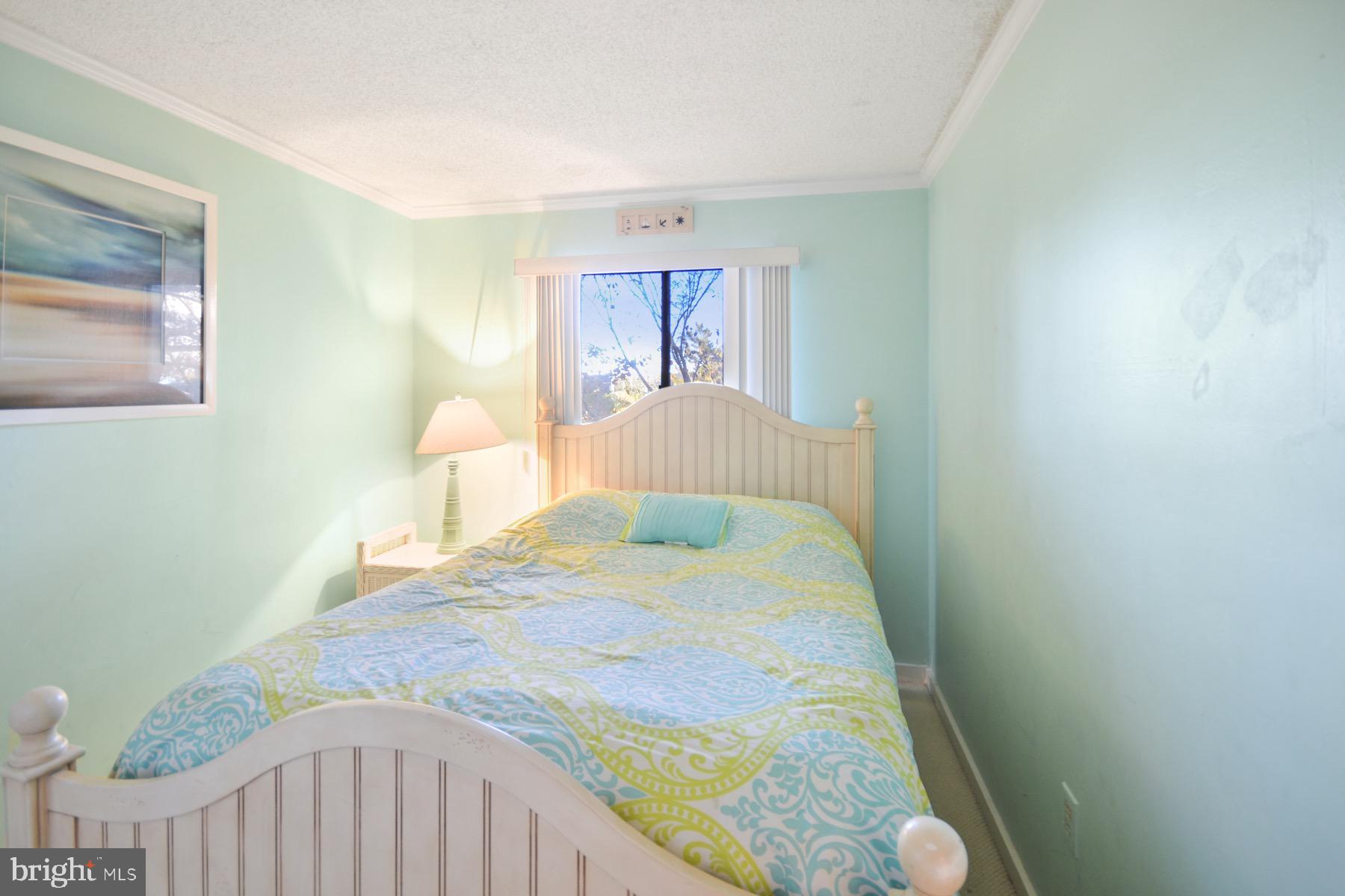 119 Old Landing Road, Unit 204J Ocean City, MD 21842 - Photo 18 of 35 a bedroom with a bed and a window