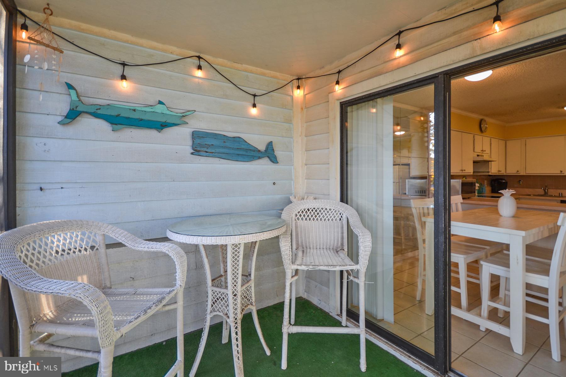 119 Old Landing Road, Unit 204J Ocean City, MD 21842 - Photo 25 of 35 a view of a patio with table and chairs and potted plants
