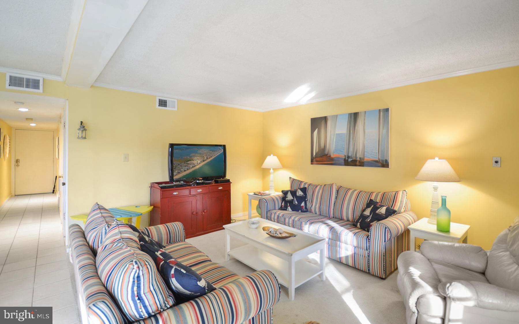 119 Old Landing Road, Unit 204J Ocean City, MD 21842 - Photo 10 of 35 a bedroom with furniture and a flat screen tv