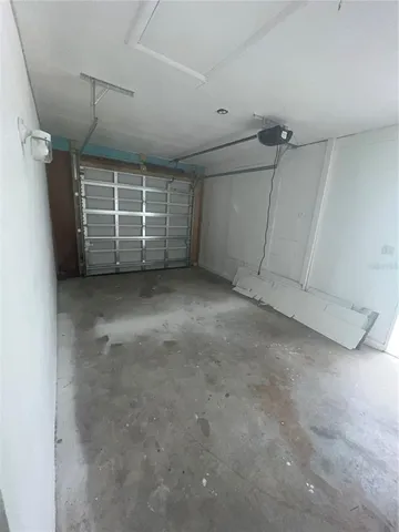 a view of a field with a tree in the background