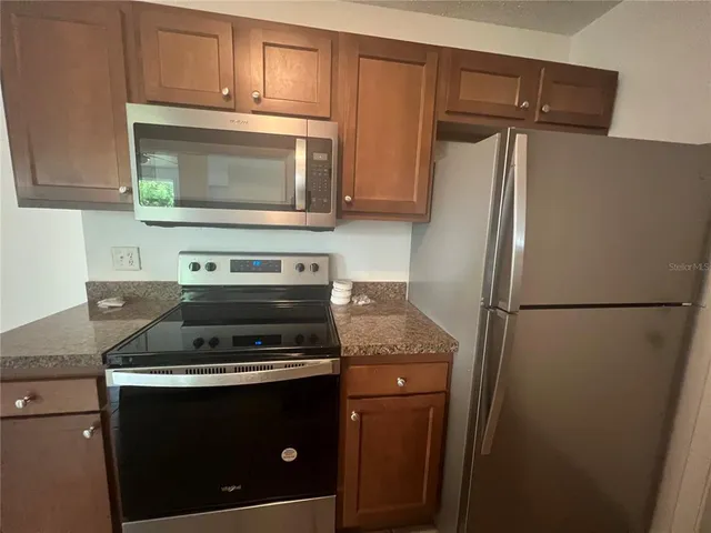 a stove top oven sitting inside of a kitchen