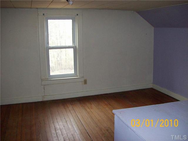 320 Burlington Road Roxboro, NC 27573 - Photo 12 of 12 an empty room with wooden floor and windows