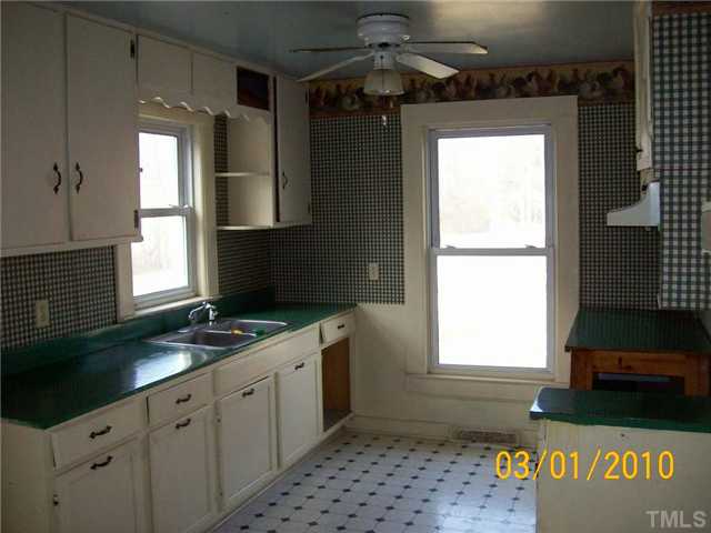 320 Burlington Road Roxboro, NC 27573 - Photo 4 of 12 a kitchen with a sink window and cabinets
