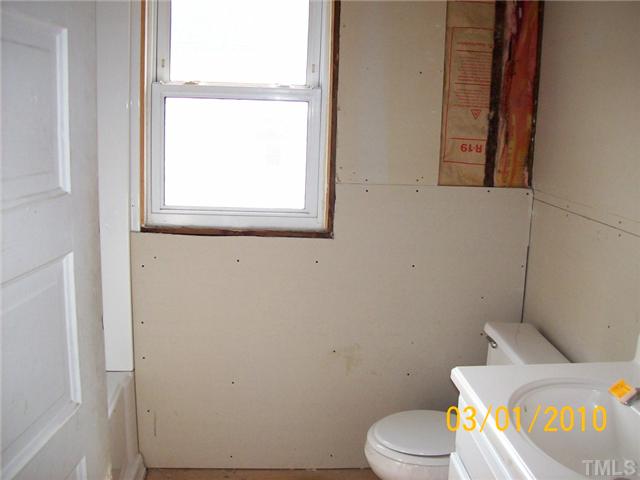 320 Burlington Road Roxboro, NC 27573 - Photo 6 of 12 a white toilet sitting next to a window