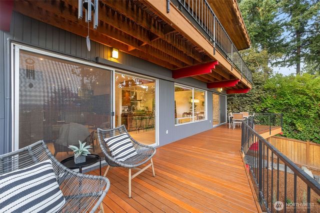 a balcony with furniture and wooden floor