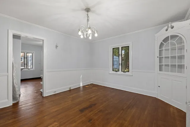 a view of livingroom with chandelier and wooden floor