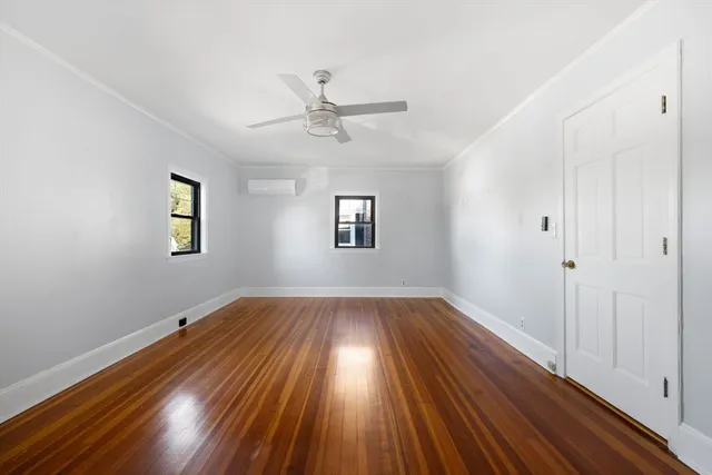 wooden floor in an empty room with a window
