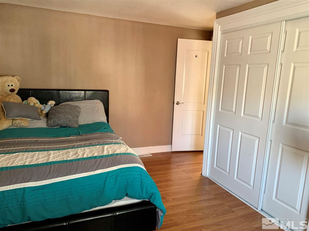 2182 Barberry Way Reno, NV 89512 - Photo 6 of 12 a living room with a bed and dresser