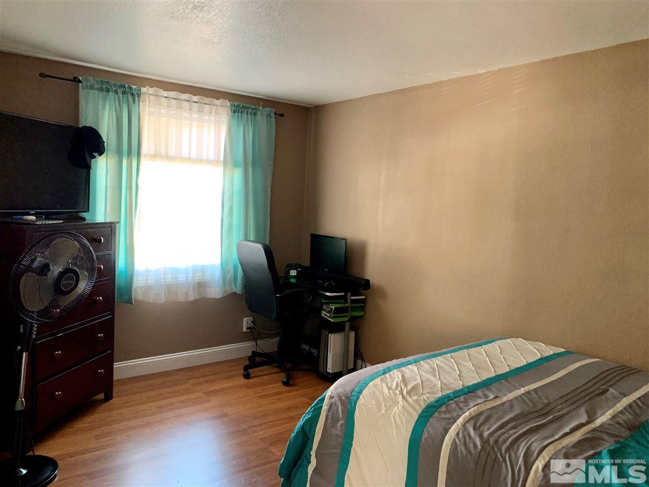 2182 Barberry Way Reno, NV 89512 - Photo 7 of 12 a bedroom with a bed and a window