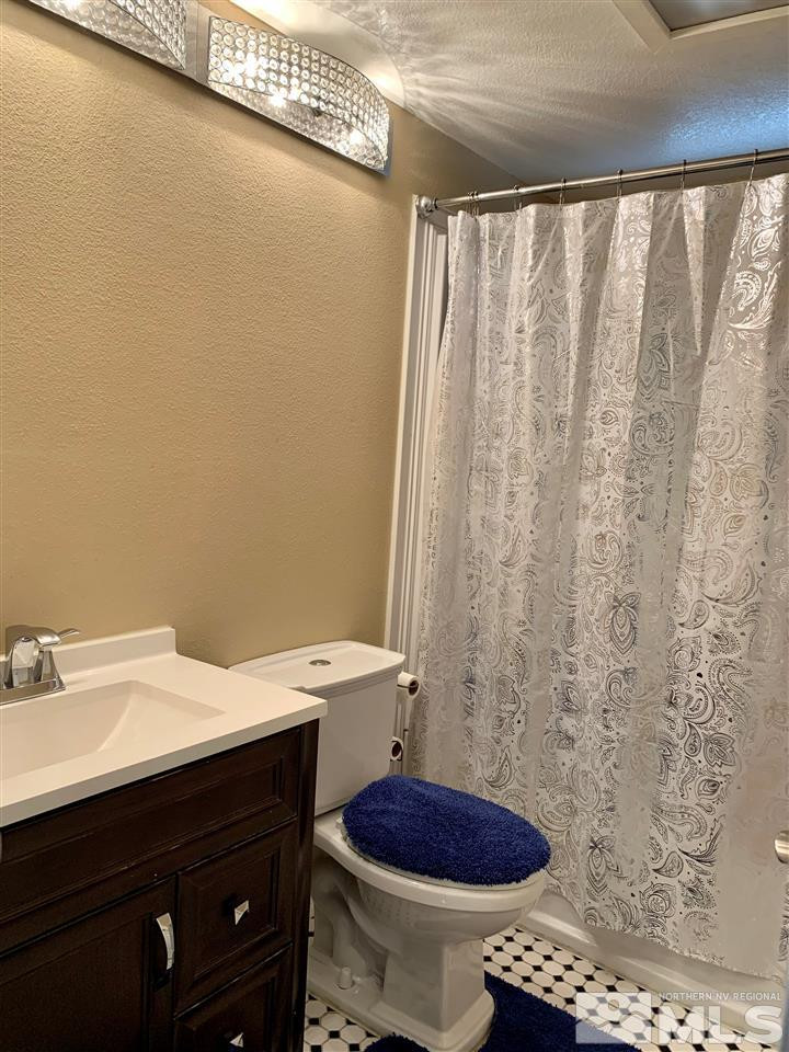 2182 Barberry Way Reno, NV 89512 - Photo 9 of 12 a bathroom with a sink a toilet and a mirror