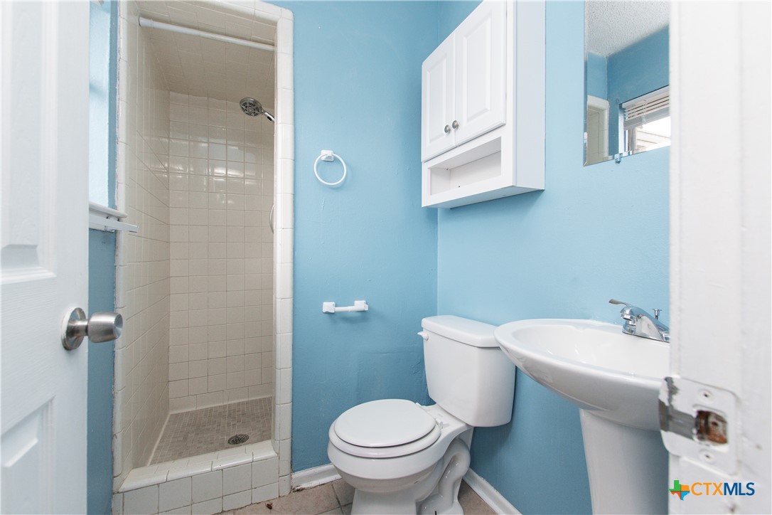 1520 McCarthy Avenue Killeen, TX 76549 - Photo 19 of 23 a bathroom with a sink toilet and shower
