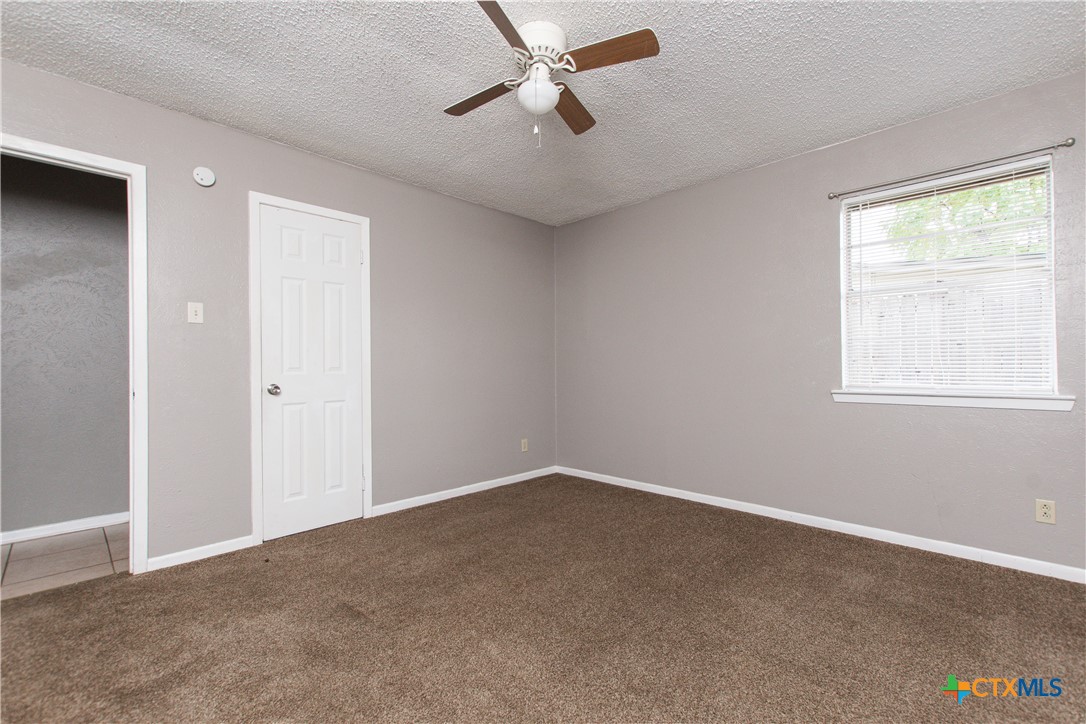 1520 McCarthy Avenue Killeen, TX 76549 - Photo 21 of 23 an empty room with windows and fan