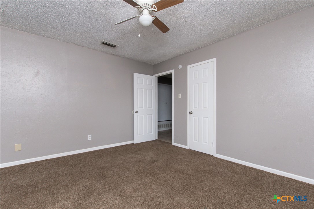 1520 McCarthy Avenue Killeen, TX 76549 - Photo 22 of 23 an empty room with chandelier fan and windows