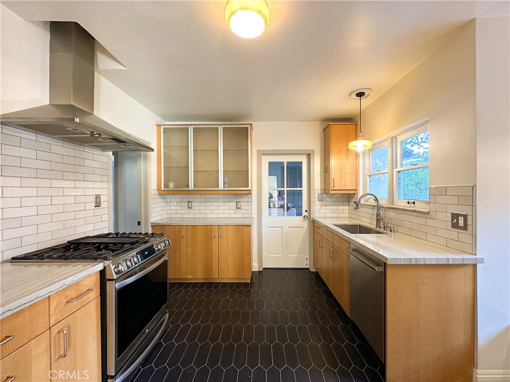 2315 North Flower Street Santa Ana, CA 92706 - Photo 3 of 20 a kitchen with stainless steel appliances granite countertop a stove and a sink