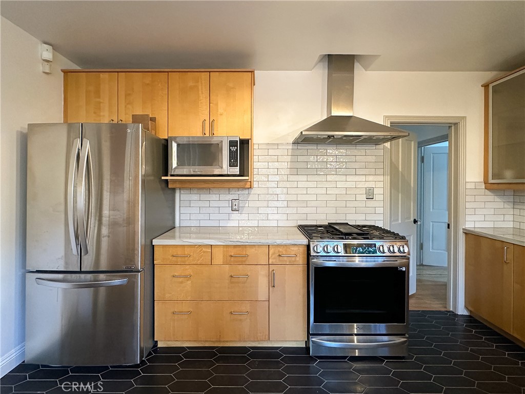 2315 North Flower Street Santa Ana, CA 92706 - Photo 4 of 20 a kitchen with a stove and a refrigerator