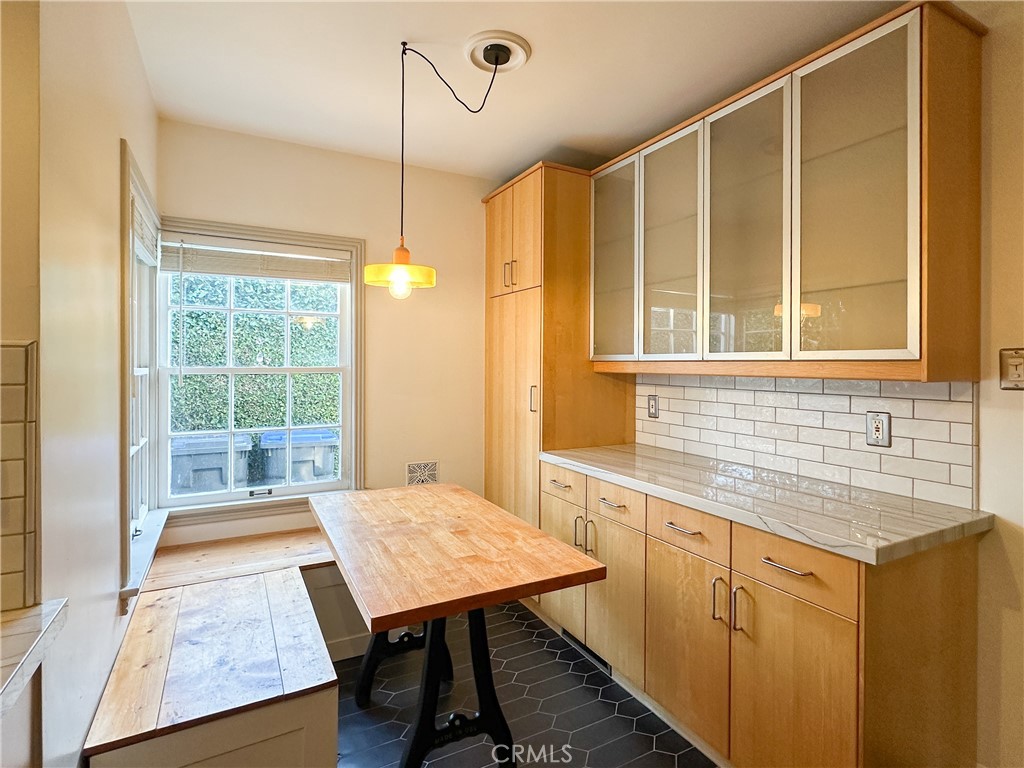 2315 North Flower Street Santa Ana, CA 92706 - Photo 6 of 20 a kitchen with a table chairs and wooden floor