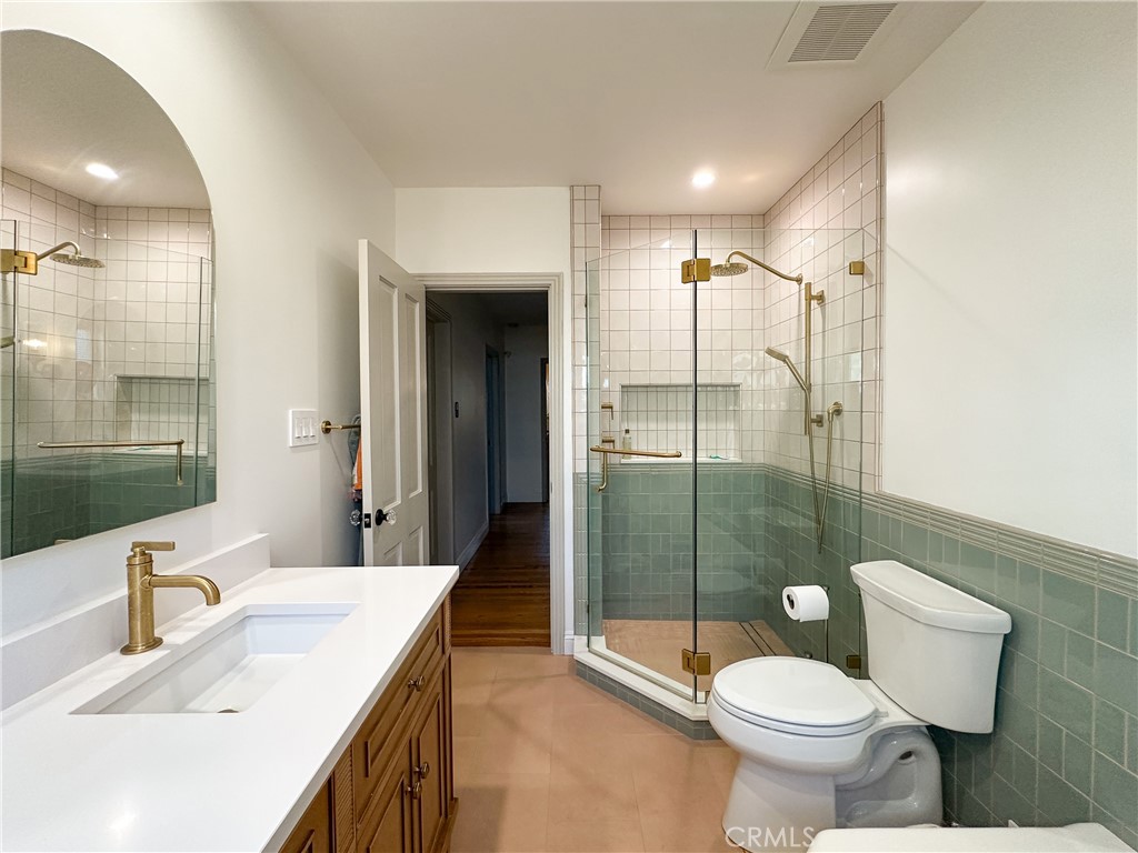 2315 North Flower Street Santa Ana, CA 92706 - Photo 9 of 20 a bathroom with a sink toilet and shower