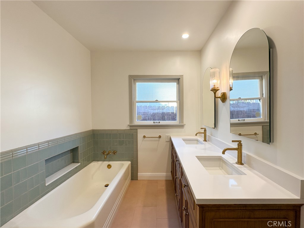 2315 North Flower Street Santa Ana, CA 92706 - Photo 10 of 20 a bathroom with a tub sink and mirror