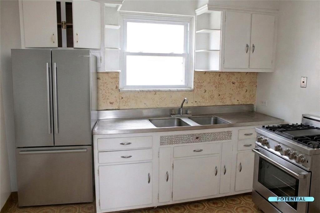 825 Liberty Street Duquesne, PA 15110 - Photo 21 of 25 a kitchen with white cabinets and white appliances