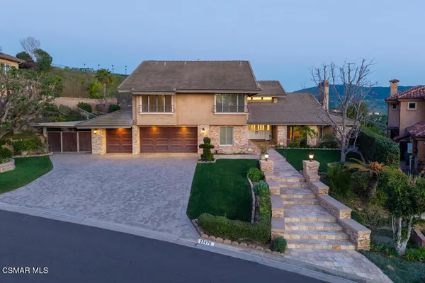 a aerial view of a house with yard and green space