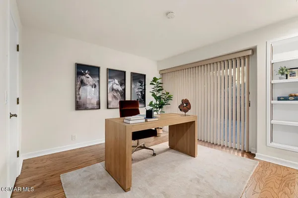 a kitchen with center island wooden floor and stainless steel appliances