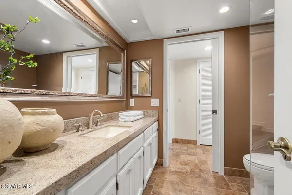 a kitchen with stainless steel appliances granite countertop a stove and a refrigerator