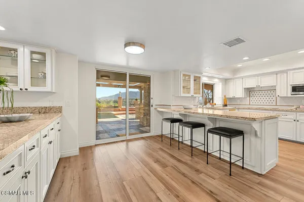 a kitchen with sink stove and cabinets