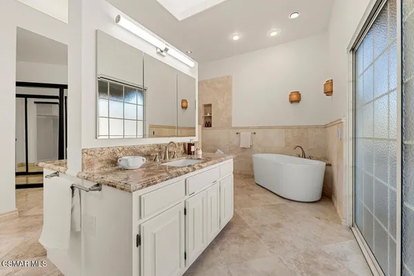 a bathroom with a glass door shower