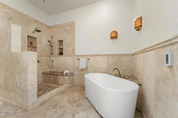 a bathroom with a granite countertop sink a toilet and shower