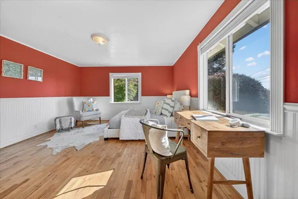 a bedroom with a large bed and a dresser