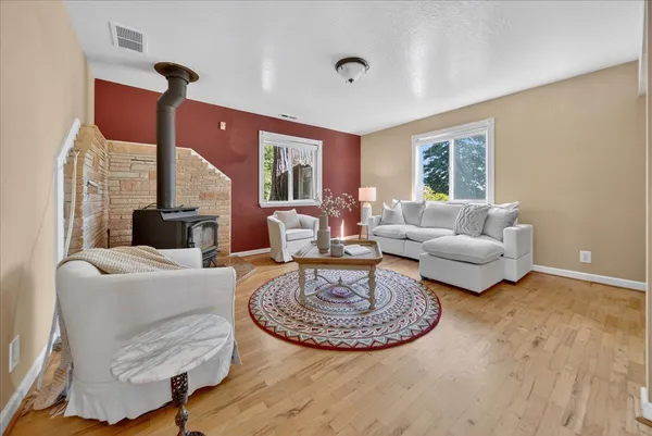 a bedroom with furniture and a wooden floor