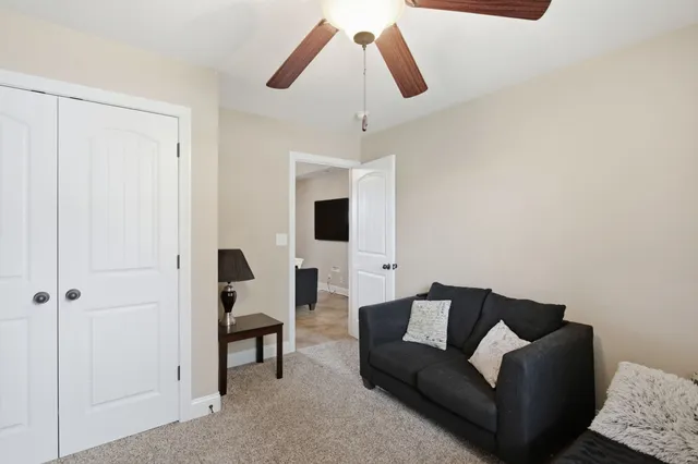 a view of an house with backyard and sitting area