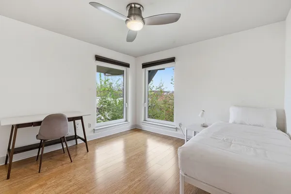 a bedroom with a bed and a chair